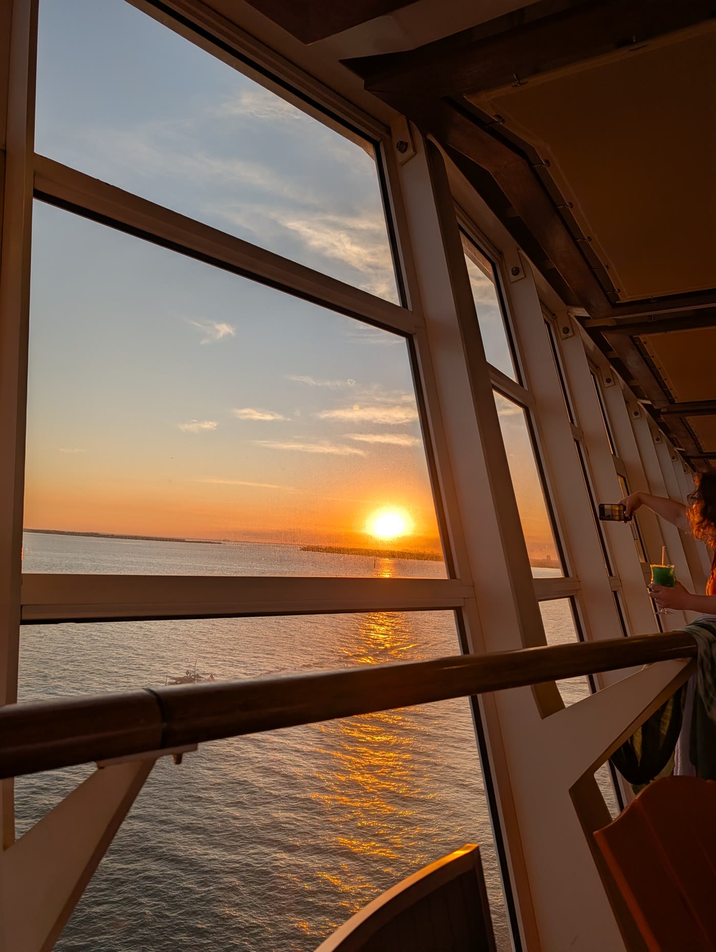 Ocean sunset from a window on Harmony of the Seas